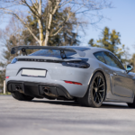 Back view Porsche Cayman GT4 on Lake Constance
